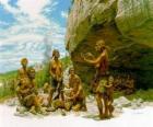 Grupa mężczyzn neandertalczyka pod ochroną schronisko rock, osób realizacji różnych działań: kamienie chartting, przygotowujących się do polowania