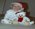 Chłopiec z Święty Mikołaj kapelusz ze swoim misiem